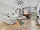 Spacious living room featuring a large sectional sofa, stone fireplace and a beautiful rug at 6817 Riverview Blvd, Bradenton, FL 34209