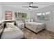 Bright bedroom with two twin beds and a ceiling fan at 6817 Riverview Blvd, Bradenton, FL 34209