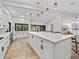 Large kitchen island with white cabinets and quartz countertops at 6817 Riverview Blvd, Bradenton, FL 34209