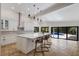 Modern white kitchen with large island, stainless steel appliances and breakfast bar at 6817 Riverview Blvd, Bradenton, FL 34209