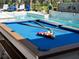 Blue pool table with cues and balls ready to play at 7317 Crape Myrtle Way, Sarasota, FL 34241