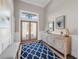 Bright and spacious entryway with wood flooring and double doors at 7317 Crape Myrtle Way, Sarasota, FL 34241