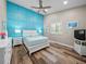 Bedroom with a teal accent wall and white bed at 7317 Crape Myrtle Way, Sarasota, FL 34241