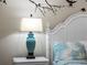White nightstand with a teal lamp in a bedroom at 7317 Crape Myrtle Way, Sarasota, FL 34241