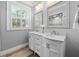 Double vanity bathroom with marble countertop at 7317 Crape Myrtle Way, Sarasota, FL 34241