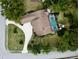 Birds-eye view of the home with well manicured lawn, long driveway, and screened in pool at 7317 Crape Myrtle Way, Sarasota, FL 34241