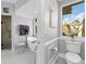 Bathroom featuring white cabinets, free standing tub, and a seamless glass shower at 7317 Crape Myrtle Way, Sarasota, FL 34241