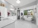 Spacious bathroom featuring a soaking tub, vanity with white cabinets, and a glass-enclosed shower at 7317 Crape Myrtle Way, Sarasota, FL 34241