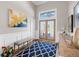 Elegant entryway featuring a stylish rug, bench, and statement art piece at 7317 Crape Myrtle Way, Sarasota, FL 34241
