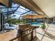 Outdoor kitchen and lounge area by the refreshing pool at 7317 Crape Myrtle Way, Sarasota, FL 34241