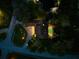 Night aerial view showing home, pool, and landscape lighting at 7317 Crape Myrtle Way, Sarasota, FL 34241