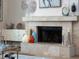 Living room fireplace features stone details, with elegant decor creating a cozy and inviting atmosphere at 7317 Crape Myrtle Way, Sarasota, FL 34241