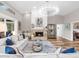 Spacious living room featuring a fireplace, hardwood floors, and ample natural light at 7317 Crape Myrtle Way, Sarasota, FL 34241