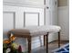 Light beige fabric bench with wooden legs in the entryway at 7317 Crape Myrtle Way, Sarasota, FL 34241