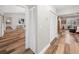 Hallway offers wood-look floors, white louvered closet doors, and access to multiple rooms at 7317 Crape Myrtle Way, Sarasota, FL 34241