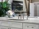 Close-up showcasing a stylish sink with a modern faucet and sprayer, complemented by white cabinetry and marble countertops at 7317 Crape Myrtle Way, Sarasota, FL 34241