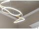 Close-up of a modern, spiral-shaped lighting fixture on the ceiling at 7317 Crape Myrtle Way, Sarasota, FL 34241