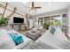 Sunlit living room with sliding glass doors to the pool and a unique wooden accent wall at 7317 Crape Myrtle Way, Sarasota, FL 34241