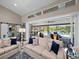 Spacious living room with access to the pool and patio through large sliding glass doors at 7317 Crape Myrtle Way, Sarasota, FL 34241
