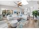 A spacious living area featuring stylish seating, natural light and seamless access to outdoor dining at 7317 Crape Myrtle Way, Sarasota, FL 34241