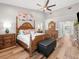 Spacious main bedroom boasts a ceiling fan, hardwood floors, and an en suite bathroom at 7317 Crape Myrtle Way, Sarasota, FL 34241
