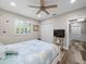Bedroom with white bed and built-in closet at 7317 Crape Myrtle Way, Sarasota, FL 34241