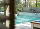 Inviting pool with waterfall feature and mosaic tile, surrounded by lush landscaping at 7317 Crape Myrtle Way, Sarasota, FL 34241