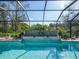 The pool features a waterfall feature and is surrounded by lush landscaping at 7317 Crape Myrtle Way, Sarasota, FL 34241