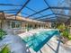 Resort-style pool with a covered patio and outdoor seating at 7317 Crape Myrtle Way, Sarasota, FL 34241