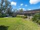 Large backyard with a hot tub, screened enclosure, and lush landscaping at 7317 Crape Myrtle Way, Sarasota, FL 34241