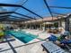 Inviting pool area with covered patio and lounge chairs at 7317 Crape Myrtle Way, Sarasota, FL 34241