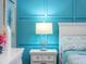 White nightstand with a modern lamp in bedroom at 7317 Crape Myrtle Way, Sarasota, FL 34241