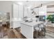 White kitchen with stainless steel appliances and quartz countertops at 7317 Crape Myrtle Way, Sarasota, FL 34241