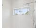 Spacious shower with wave patterned tile and a window at 854 Macewen Dr, Osprey, FL 34229