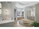Spa-like bathroom with a large soaking tub, walk-in shower, and modern vanity at 854 Macewen Dr, Osprey, FL 34229