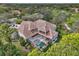 Aerial view of home showcasing tile roof, pool, and lush landscaping at 854 Macewen Dr, Osprey, FL 34229