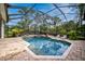 Relaxing screened pool area with fire features and lounge chairs at 854 Macewen Dr, Osprey, FL 34229