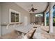 Covered outdoor kitchen with large dining table and seating at 854 Macewen Dr, Osprey, FL 34229