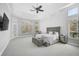 Bright main bedroom with a large bed, plenty of natural light, and a ceiling fan at 854 Macewen Dr, Osprey, FL 34229