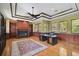 Home office with built-in shelves, fireplace and hardwood floors at 854 Macewen Dr, Osprey, FL 34229