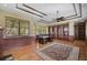 Spacious home office with built-in bookshelves, hardwood floors, and large windows at 854 Macewen Dr, Osprey, FL 34229