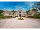 Elegant home with fountain, lush landscaping and circular driveway at 854 Macewen Dr, Osprey, FL 34229