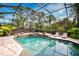 Inviting screened pool and spa with fire pit and lush landscaping at 854 Macewen Dr, Osprey, FL 34229