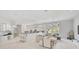 Open concept kitchen features white cabinets, island, and breakfast bar at 854 Macewen Dr, Osprey, FL 34229