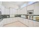 White kitchen with granite countertops and ample cabinet space at 854 Macewen Dr, Osprey, FL 34229