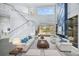 Spacious living room with a modern fireplace and pool view at 854 Macewen Dr, Osprey, FL 34229