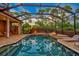 Expansive pool and patio area with fire pit and outdoor kitchen at 854 Macewen Dr, Osprey, FL 34229