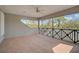 Spacious screened porch with tile flooring and ceiling fan at 854 Macewen Dr, Osprey, FL 34229