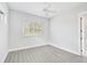 Bright and airy bedroom with large window and wood-look flooring at 854 Macewen Dr, Osprey, FL 34229