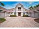 Large home with three-car garage and manicured landscaping at 854 Macewen Dr, Osprey, FL 34229